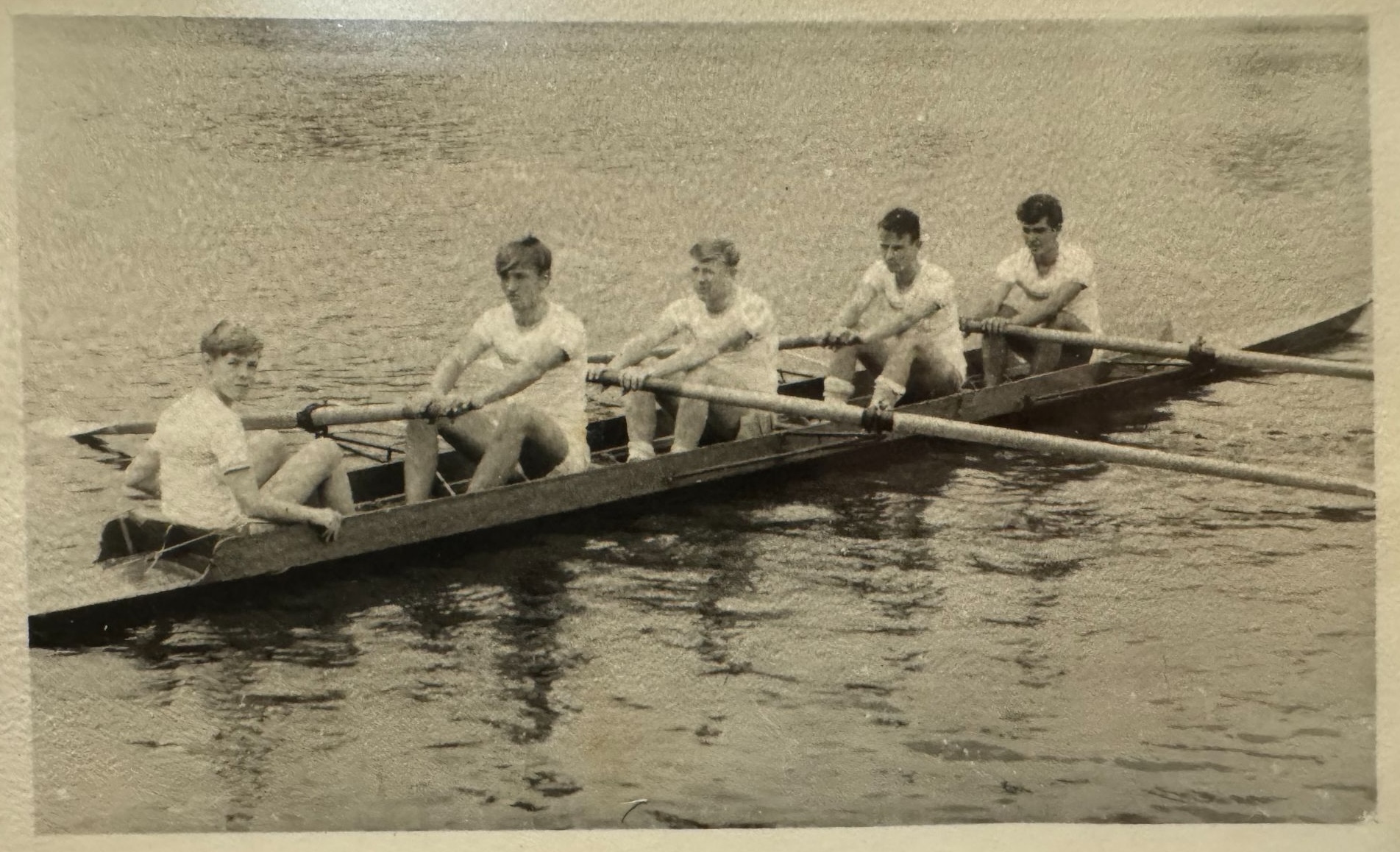Black and white photo of Bob rowing in High School